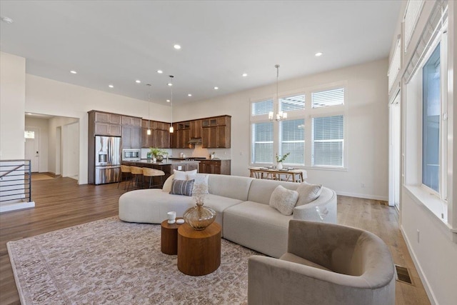4756 W Lex Ave, Spokane, WA 99208 - living area featuring light wood-style flooring, a chandelier, recessed lighting, and baseboards