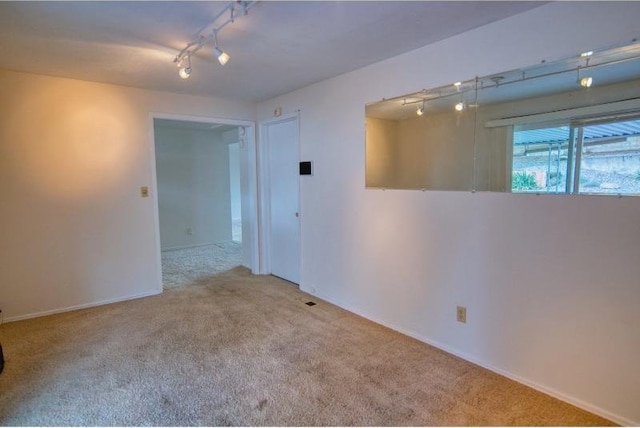 5516 N Fleming St, Spokane, WA 99205 - empty room with carpet flooring, baseboards, and track lighting