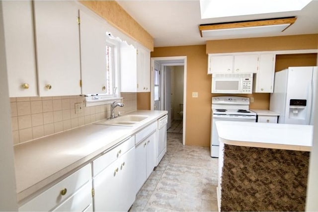 5516 N Fleming St, Spokane, WA 99205 - kitchen featuring white appliances, a sink, white cabinets, backsplash, and light countertops