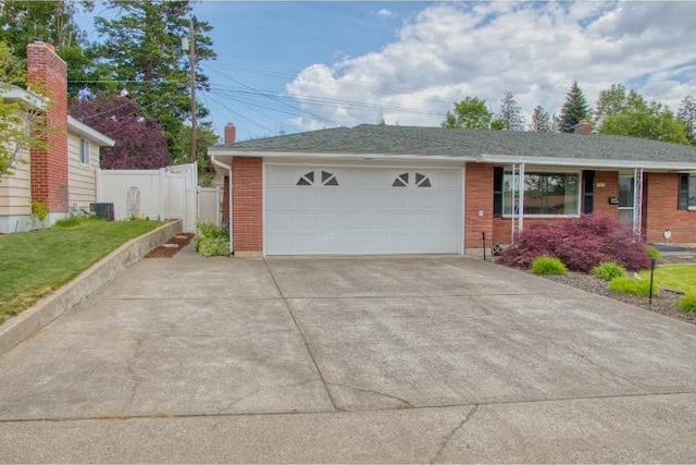 5516 N Fleming St, Spokane, WA 99205 - view of front of home featuring a garage, brick siding, and central air condition unit