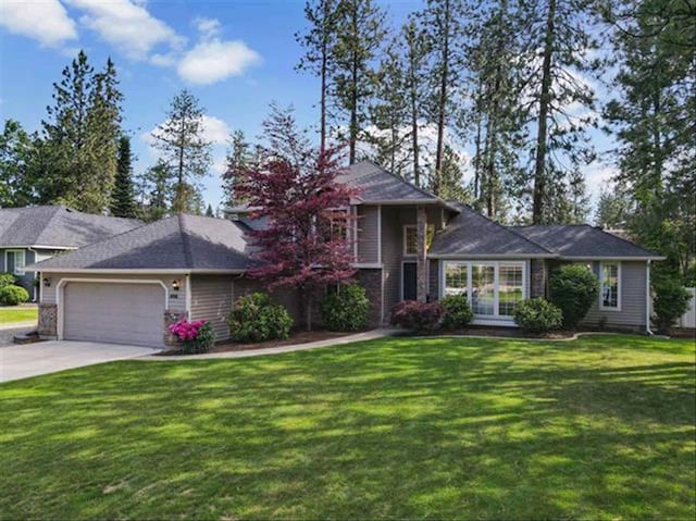 1216 W Candlewood Ct, Spokane, WA 99218 - view of front of property featuring an attached garage, a front lawn, and concrete driveway