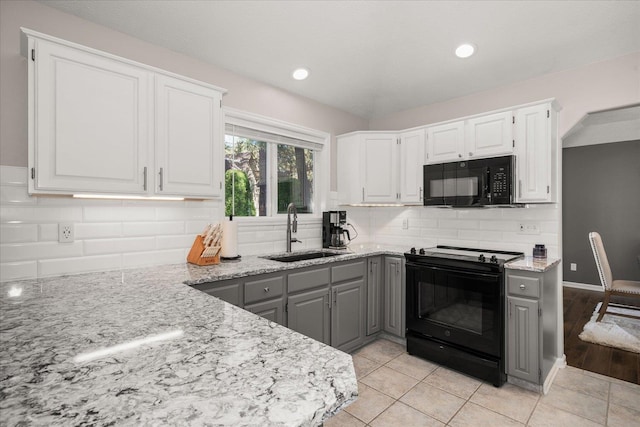 1216 W Candlewood Ct, Spokane, WA 99218 - kitchen featuring black appliances, a sink, gray cabinetry, light stone counters, and white cabinetry