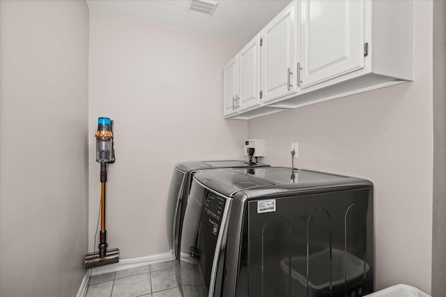 1216 W Candlewood Ct, Spokane, WA 99218 - laundry area featuring washing machine and clothes dryer, cabinet space, baseboards, and light tile patterned flooring