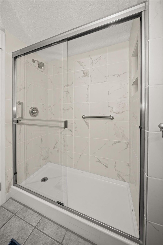 1216 W Candlewood Ct, Spokane, WA 99218 - full bathroom featuring a stall shower and tile patterned flooring