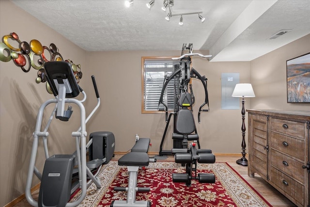 1216 W Candlewood Ct, Spokane, WA 99218 - workout area with a textured ceiling and baseboards