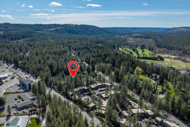 1216 W Candlewood Ct, Spokane, WA 99218 - aerial view of property and surrounding area featuring a heavily wooded area and a mountain backdrop