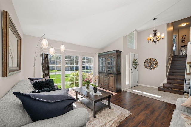 1216 W Candlewood Ct, Spokane, WA 99218 - living room featuring a chandelier, stairway, wood finished floors, baseboards, and vaulted ceiling