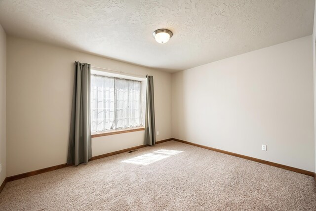 1811 S Canyon Woods Ln, Spokane, WA 99224 - empty room with light carpet, baseboards, and a textured ceiling