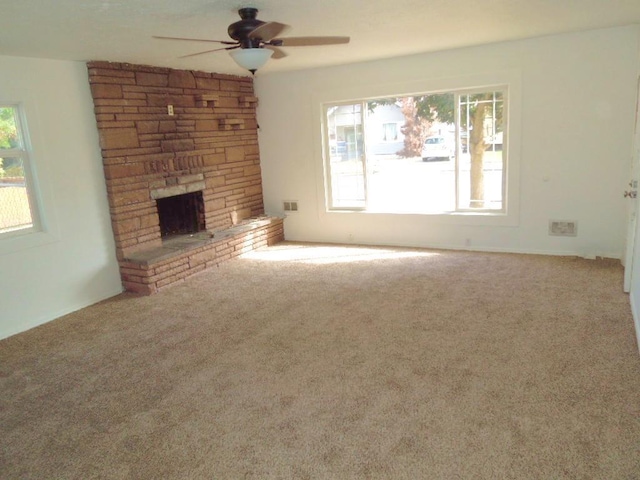 917 E Walton Ave, Spokane, WA 99207 - unfurnished living room with a ceiling fan, a fireplace, and carpet
