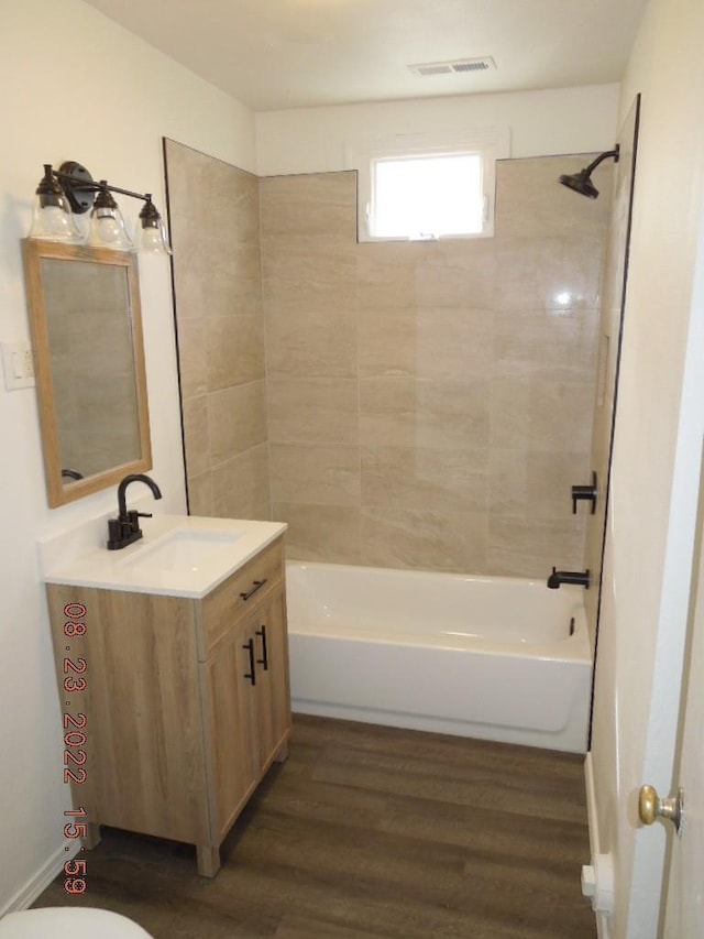 917 E Walton Ave, Spokane, WA 99207 - full bath featuring vanity, wood finished floors, bathtub / shower combination, and toilet