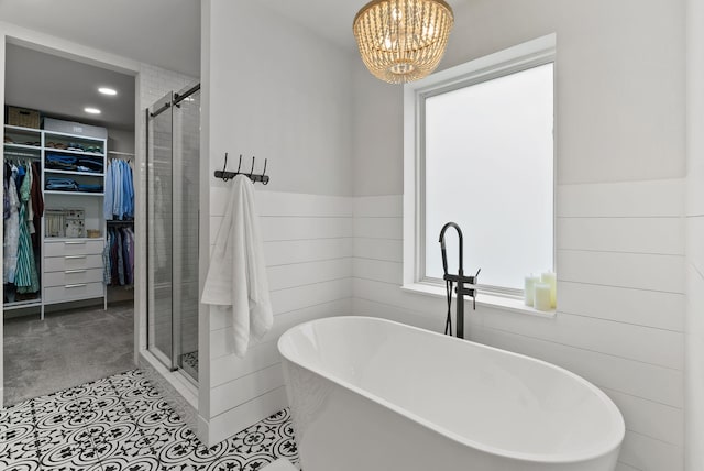 2419 C Indian Ridge Rd, Chewelah, WA 99109 - bathroom featuring a spacious closet, a shower stall, a freestanding tub, a chandelier, and wainscoting
