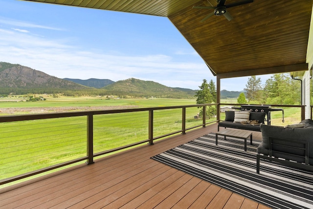 2419 C Indian Ridge Rd, Chewelah, WA 99109 - wooden terrace with a mountain view, an outdoor living space, a ceiling fan, and a view of countryside