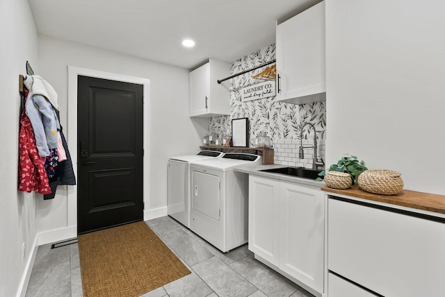 2419 C Indian Ridge Rd, Chewelah, WA 99109 - laundry area with washing machine and dryer, cabinet space, bar with sink, light tile patterned flooring, and recessed lighting