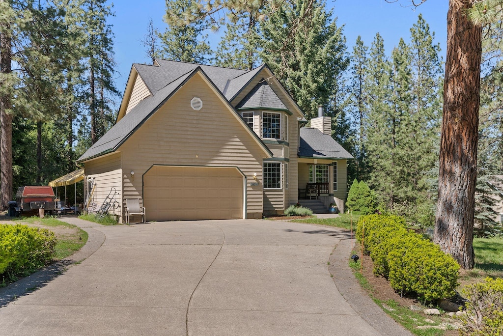 24519 E Moffat Rd, Newman Lake, WA 99025 - view of front of property with driveway, a chimney, and an attached garage
