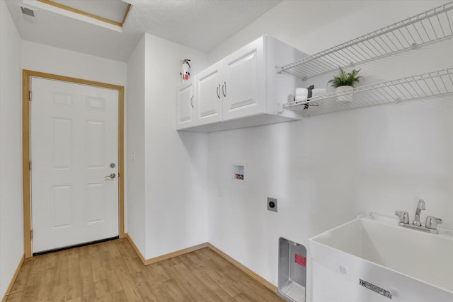 1002 N Oasis Ave, Deer Park, WA 99006 - laundry room with cabinet space, light wood-type flooring, washer hookup, hookup for an electric dryer, and baseboards