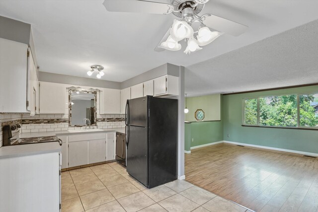 3424 E 32nd Ave, Spokane, WA 99223 - kitchen with black appliances, a sink, tasteful backsplash, light countertops, and white cabinets