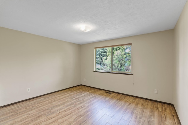 3424 E 32nd Ave, Spokane, WA 99223 - empty room with light wood-style floors, baseboards, and a textured ceiling