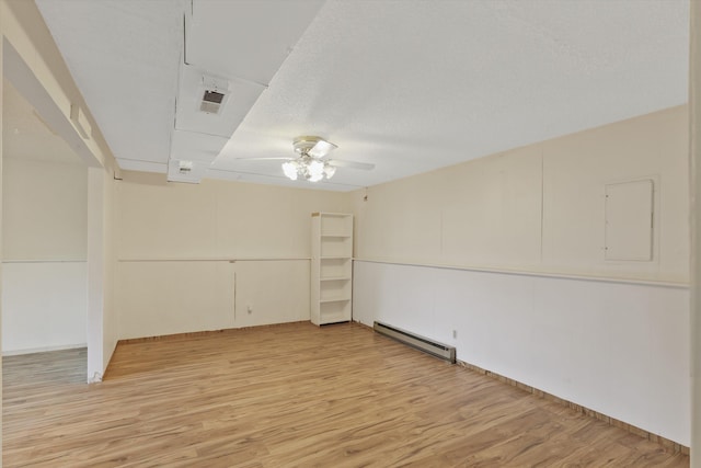 3424 E 32nd Ave, Spokane, WA 99223 - spare room with a baseboard radiator, a ceiling fan, and light wood-type flooring