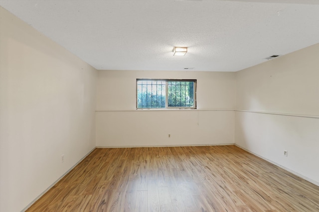 3424 E 32nd Ave, Spokane, WA 99223 - empty room with light wood-style flooring, baseboards, and a textured ceiling