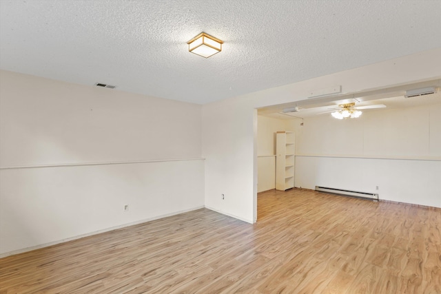 3424 E 32nd Ave, Spokane, WA 99223 - empty room featuring a baseboard radiator, light wood-type flooring, ceiling fan, and a textured ceiling