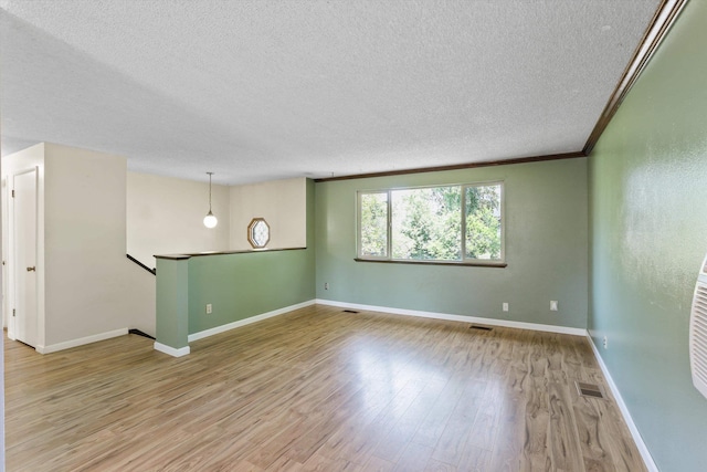 3424 E 32nd Ave, Spokane, WA 99223 - empty room featuring a textured ceiling, wood finished floors, and baseboards