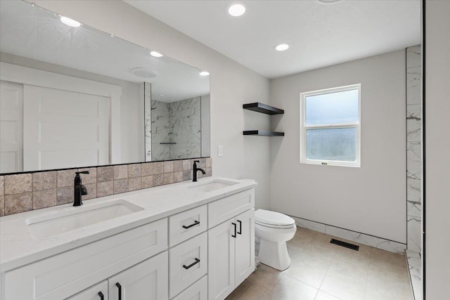 12510 N Craig Rd, Nine Mile Falls, WA 99026 - bathroom featuring toilet, double vanity, a marble finish shower, recessed lighting, and decorative backsplash