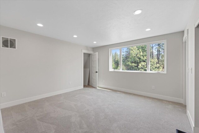 12510 N Craig Rd, Nine Mile Falls, WA 99026 - unfurnished bedroom featuring baseboards, recessed lighting, and light carpet