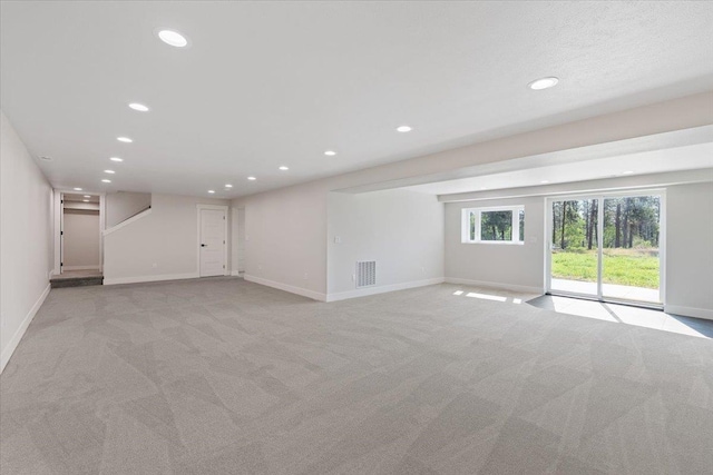 12510 N Craig Rd, Nine Mile Falls, WA 99026 - unfurnished living room featuring recessed lighting, light colored carpet, and baseboards