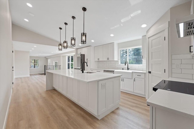 12510 N Craig Rd, Nine Mile Falls, WA 99026 - kitchen featuring a sink, light wood-type flooring, tasteful backsplash, recessed lighting, and lofted ceiling