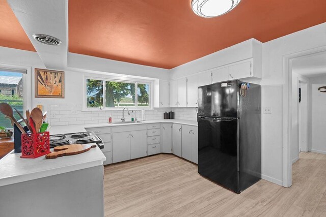 611 E Mill St, Latah, WA 99018 - kitchen with freestanding refrigerator, a sink, tasteful backsplash, and light countertops