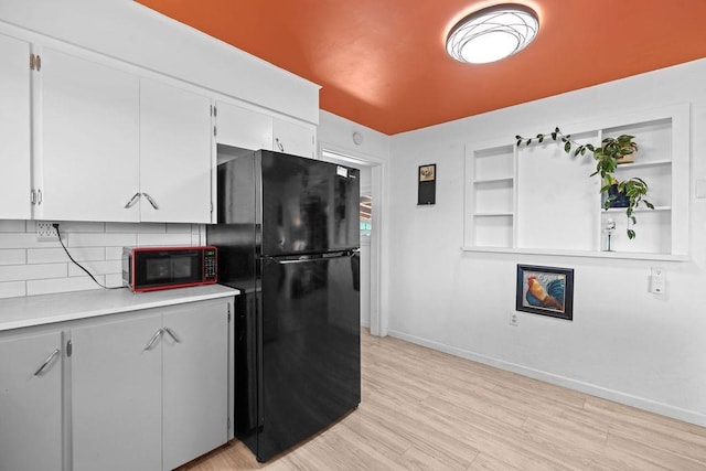 611 E Mill St, Latah, WA 99018 - kitchen with black appliances, light countertops, baseboards, white cabinetry, and decorative backsplash