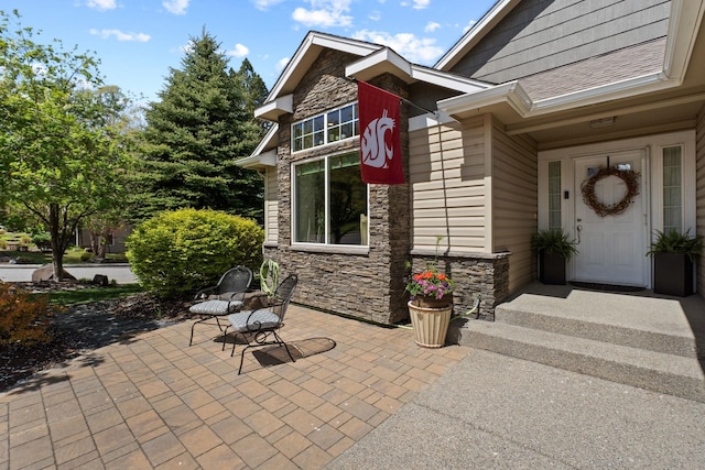 526 W Willapa Ct, Spokane, WA 99224 - view of exterior entry featuring stone siding and a patio area