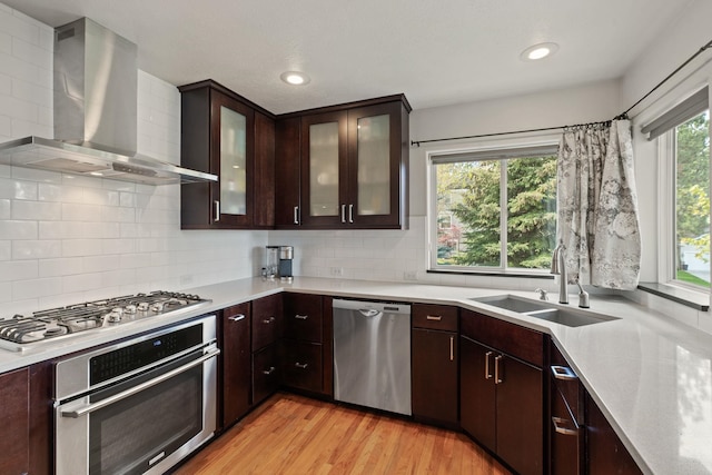 526 W Willapa Ct, Spokane, WA 99224 - kitchen featuring stainless steel appliances, a sink, wall chimney exhaust hood, light countertops, and recessed lighting
