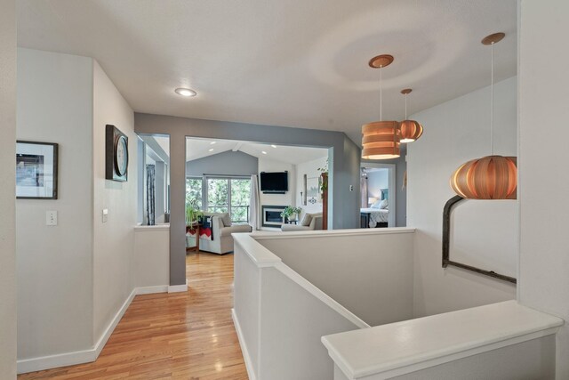 526 W Willapa Ct, Spokane, WA 99224 - hall with light wood finished floors, lofted ceiling, baseboards, an upstairs landing, and recessed lighting
