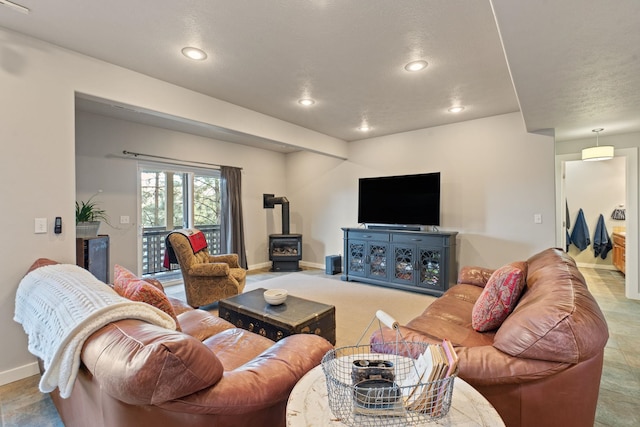 526 W Willapa Ct, Spokane, WA 99224 - living area featuring a wood stove, baseboards, and recessed lighting