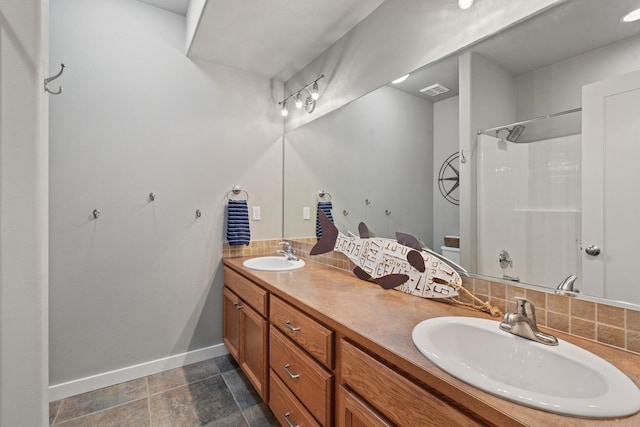 526 W Willapa Ct, Spokane, WA 99224 - bathroom with double vanity, decorative backsplash, a shower, and baseboards