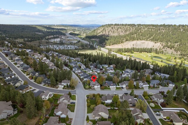 526 W Willapa Ct, Spokane, WA 99224 - aerial view of property and surrounding area featuring a forest, nearby suburban area, and a mountainous background