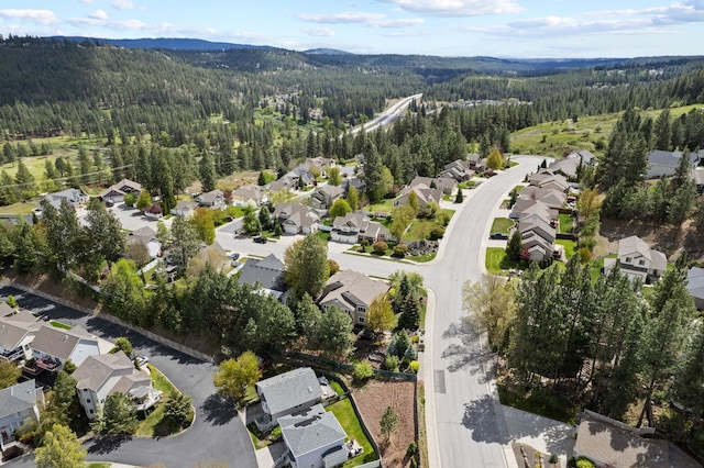 526 W Willapa Ct, Spokane, WA 99224 - aerial view of property's location with a heavily wooded area, nearby suburban area, and a mountainous background