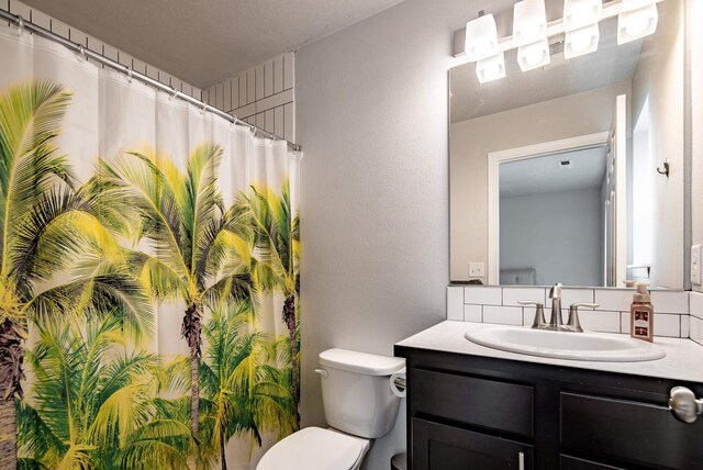 704 E Canterbury Ln, Colbert, WA 99005 - bathroom with vanity, toilet, decorative backsplash, and a shower with shower curtain