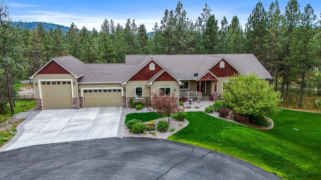 13906 E 39th Ln, Veradale, WA 99037 - craftsman-style house with a garage, covered porch, concrete driveway, a front lawn, and stone siding