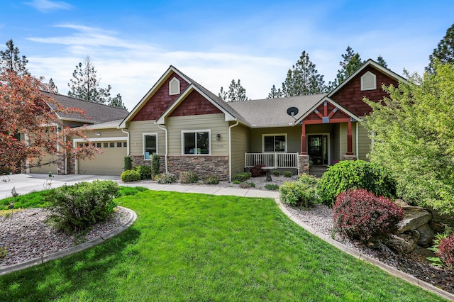 13906 E 39th Ln, Veradale, WA 99037 - craftsman inspired home featuring covered porch, stone siding, a front yard, a garage, and roof with shingles