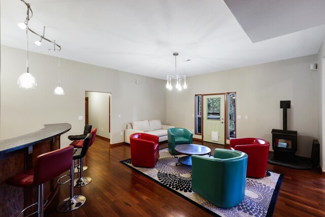 13906 E 39th Ln, Veradale, WA 99037 - living room with wood finished floors, a wood stove, a bar, and baseboards