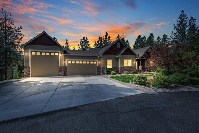 13906 E 39th Ln, Veradale, WA 99037 - view of front of home with an attached garage, stone siding, and driveway