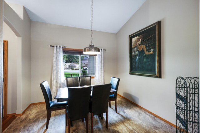 13906 E 39th Ln, Veradale, WA 99037 - dining room featuring arched walkways, baseboards, and vaulted ceiling