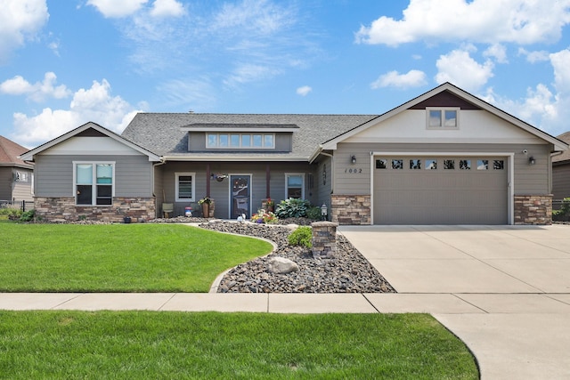 1002 N High Desert Dr, Deer Park, WA 99006 - craftsman house featuring stone siding, concrete driveway, a front yard, a garage, and a shingled roof