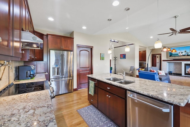 1002 N High Desert Dr, Deer Park, WA 99006 - kitchen featuring stainless steel appliances, a sink, wall chimney range hood, light wood finished floors, and open floor plan