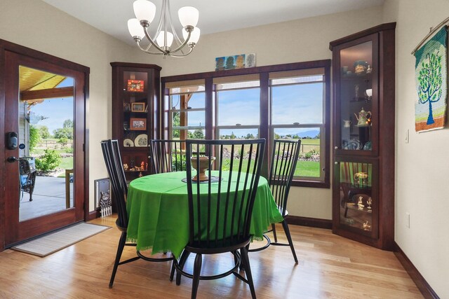 1002 N High Desert Dr, Deer Park, WA 99006 - dining area with a chandelier, light wood-style floors, and baseboards