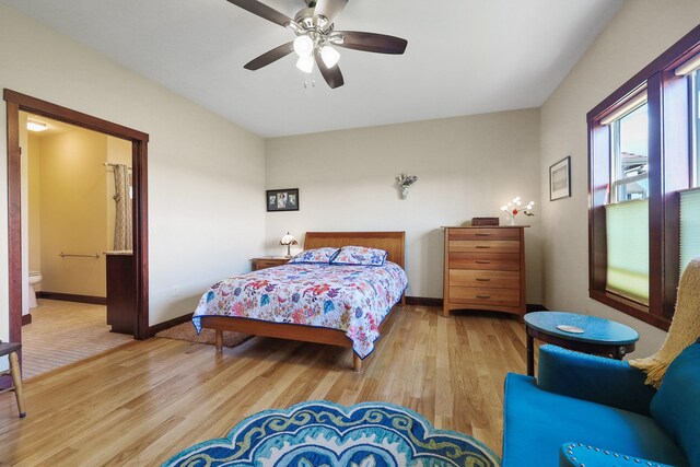 1002 N High Desert Dr, Deer Park, WA 99006 - bedroom featuring wood finished floors, baseboards, a ceiling fan, and connected bathroom