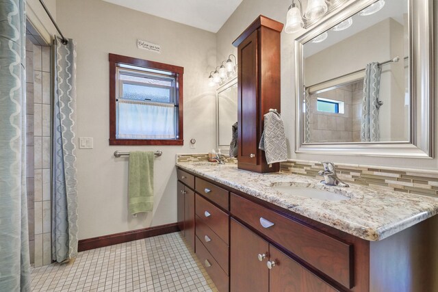 1002 N High Desert Dr, Deer Park, WA 99006 - bathroom featuring double vanity, baseboards, and curtained shower
