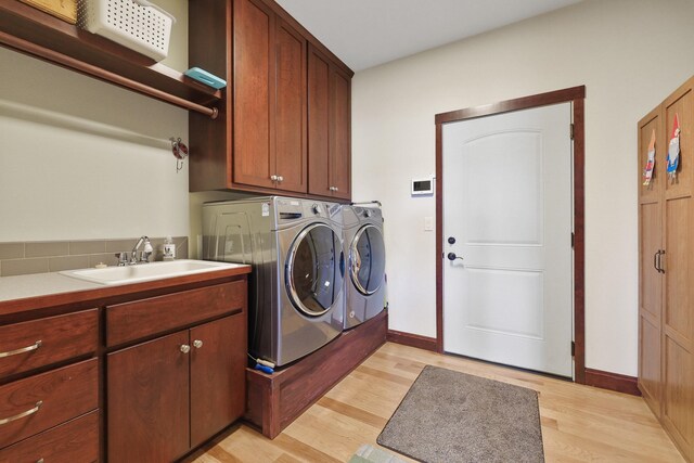 1002 N High Desert Dr, Deer Park, WA 99006 - laundry room featuring light wood-style flooring, independent washer and dryer, cabinet space, and baseboards